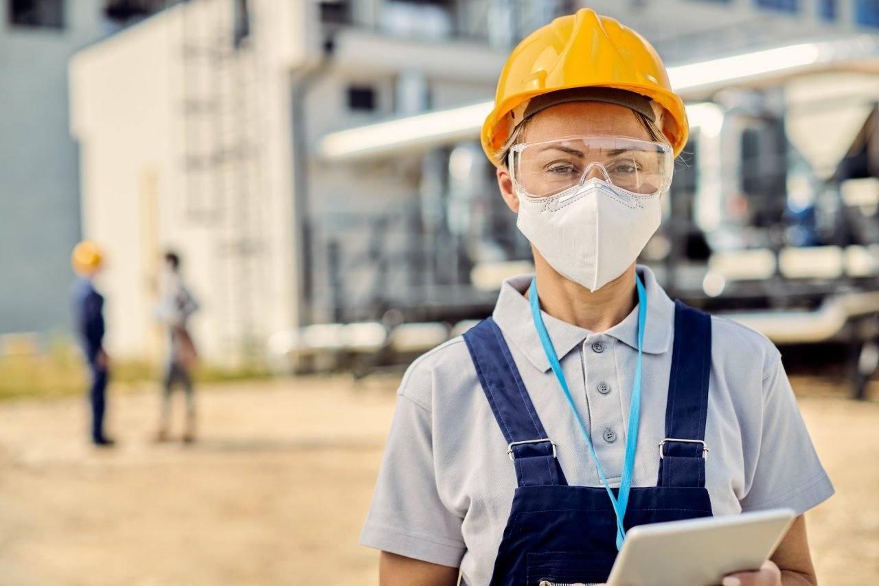 female-building-contractor-with-digital-tablet-wearing-face-mask-at-construction-site-.jpg